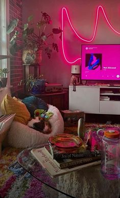 a living room filled with lots of furniture and a flat screen tv mounted to the wall