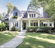 a white house with black shutters on the front and side windows is seen in this google street view