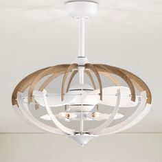 a white light fixture with wood accents hanging from the ceiling