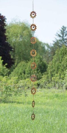 a wind chime hanging in the middle of a field