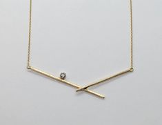 Diamond & Gold Necklace - Handmade 14k yellow gold pendant with unique bar design is punctuated with a round, modern, brilliant cut diamond (0.1ctw, SI/G).  Contemporary and elegant, this makes the perfect accent to any outfit.<br><br>Finished with a lobster clasp closure. Modern Diamond Cut Necklace, Modern 14k White Gold Diamond Necklace, Modern 14k Gold Diamond Necklace With Accents, Modern 14k Yellow Gold Diamond Necklace, Modern Gold Diamond Necklace, Modern Pendant Diamond Necklace With Single Diamond, Modern Yellow Gold Diamond Necklace For Anniversary, Modern Formal Diamond Necklace With Single Diamond, Modern Single Diamond Pendant Necklace