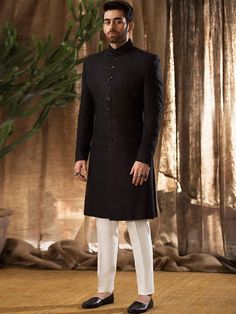 Sherwani:Color: BlackFabric: Raw SilkSherwani features rich quality embellishments accent on collarFanciful front button closure  Inner:Comes with off-white kurta and pajama  Additional Accessories:Jodhpuri/Saleem Shahi Shoes: US$30 (Made with sherwani material & embroidery)  Note: Price of all sherwani suits includes only 3 pieces i.e. sherwani, kurta and pajama (or whatever bottom is mentioned in product description). Extra charges will apply for any additional accessories like shawl, turb Formal Chikankari Embroidery Straight Kurta Bandhgala, Traditional Fit Long Sleeve Sherwani For Wedding, Formal Fitted Kurta With Chikankari Embroidery, Designer Long Sleeve Sherwani For Festive Occasion, Traditional Fit Long Sleeve Wedding Sherwani, Formal Churidar With Straight Kurta For Eid, Formal Straight Kurta Churidar For Eid, Formal Nehru Jacket With Chikankari Embroidery, Formal Churidar With Chikankari Embroidery For Eid