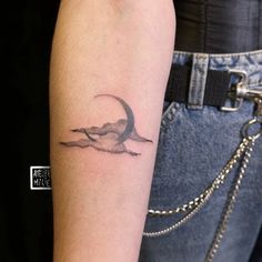 a woman's arm with a small tattoo on the left side of her arm