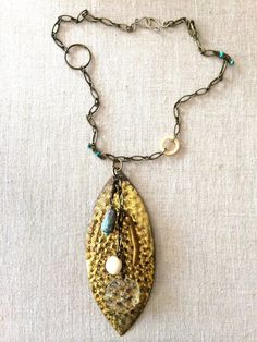 Ocean Necklace One Of A Kind Turquoise Brass Jewelry, Artisan Gold Jewelry With Vintage Charm, Bohemian Patina Bronze Necklace, Bohemian Brass Necklace With Patina, Beaded Brass Amulet Jewelry, Artisan Metal Necklaces With Patina, Artisan Metal Necklace With Patina, Artisan Necklaces With Vintage Charm, Artisan Vintage Charm Necklaces