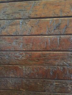 an old wooden wall with peeling paint on it