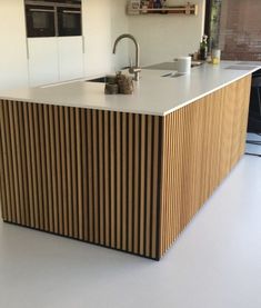 a modern kitchen with an island counter top