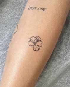 a person with a tattoo on their arm that reads london life and has a flower in it