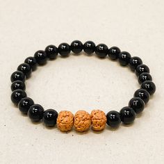 These bracelets are made using high-quality 6mm beads that come in three different sizes - Small (5inches-6inches), Medium (6inches-7inches), and Large (7inches-8inches) - to ensure a comfortable and secure fit on any wrist. Each bracelet features three Rudraksha Seed beads, which act as diffusers, releasing the essential oils into your skin as you wear them, providing the perfect dose of aromatherapy for relaxation during your busy schedule. Handmade Black Crystal Bracelet For Spiritual Purposes, Handmade Black Crystal Bracelet For Spiritual Healing, Handmade Black Crystal Bracelet For Spiritual Use, Handmade Black Crystal Bracelet In Spiritual Style, Spiritual Charm Bracelet With 8mm Beads For Meditation, Spiritual Black Bracelet With 108 Beads, Hypoallergenic Black Round Bracelets, Casual Bracelets For Meditation With 8mm Beads, Spiritual Charm Bracelet With Round Beads For Meditation