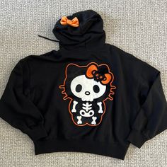 New With Tag. Hello Kitty Black Skeleton Hoodie. Size S Cute Fall Streetwear Tops, Black Hooded Top With Cartoon Print, Hello Kitty Print Top For Winter Streetwear, Black Cartoon Print Hoodie Top, Cute Black Hooded Top, Hello Kitty Print Long Sleeve Hoodie For Streetwear, Casual Hello Kitty Sweatshirt For Streetwear, Halloween Cartoon Print Hooded Top, Hooded Halloween Tops With Cartoon Print