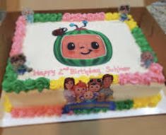 a birthday cake with an image of a cartoon character on it