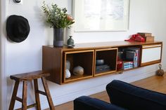 a living room with a chair, table and bookshelf