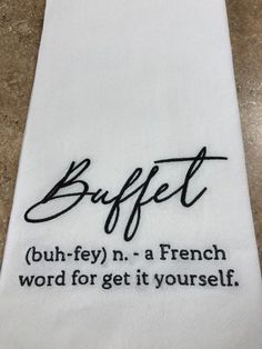 a white towel with the words buffet written in cursive writing on it,