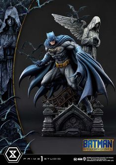 Standing atop the ruins of Gotham Cemetery, this 28-inch-tall Batman statue embodies the hero’s brooding presence and relentless spirit. Batman is captured in a powerful yet dynamic pose, his muscular physique meticulously sculpted to showcase every sinew and contour that defines his strength and agility. Ready to leap into action, his left fist grabs at his voluminous cape as it billows around him, its scalloped edge resembling bat wings caught in an unseen wind.