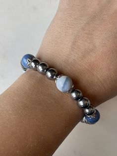 8mm round shaped, polished magnetic silver colored beads with 10mm beautiful light blue agate stone beads with the strongest 7mm magnetic clasp on the market. This bracelet is BEAUTIFUL  Every agate stone is unique.  Relieve wrist or finger inflammation pain safely and naturally!  For most people I would recommend a minimum size of 7" for this size bead. This bead would require you adding at least 1/2" more than your wrist size.  Magnetic Therapy works by creating a magnetic field that penetrate Hypoallergenic Agate Round Beads Jewelry, Silver Agate Stretch Bracelet, Silver Bracelets With Agate Round Beads, Silver Agate Bracelets With Round Beads, Silver Crystal Bracelet With Agate Gemstone Beads, Silver Agate Crystal Bracelet With Gemstone Beads, Silver Agate Crystal Bracelet With Round Beads, Silver Agate Gemstone Beads Crystal Bracelet, Silver Agate Crystal Bracelet For Gift