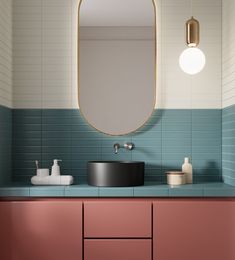 a bathroom with a sink, mirror and other items on the counter in front of it