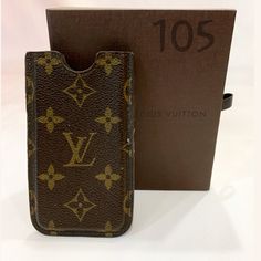 a louis vuitton cell phone case sitting next to a box