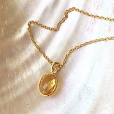 A beautiful dainty citrine jewel is set into an oval gold vermeil frame and hangs on a matching 18kt gold vemeil chain.  Lovely and elegant on its own, or it can be so easily layered with other gold necklaces.The faceted citrine jewel is surrounded by gold vermeil. There is no back to the pendant so the light shines through showing the pretty yellow color.   Citrine is the November birthstone, it is said to attract wealth, prosperity and success.* Citrine charm 12mm ( 1/2 inch) * 16” (40cm) or 1 Gold Ruby Necklace, Watermelon Tourmaline Necklace, Surfer Jewelry, Yellow Gems, Pretty Yellow, Citrine Jewelry, Surfer Necklace, Birthday Jewelry, Hammered Earrings