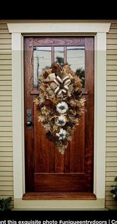 a wreath on the front door of a house