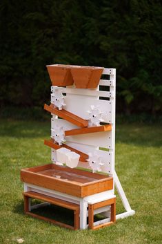 a white and wooden structure sitting in the grass