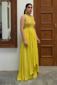 Citric yellow pure crepe high-low anarkali with cutdana, poth and nakshi jaal embroidered yoke. Comes with palazzo.
Components: 2
Pattern: Embroidered
Type Of Work: Cutdana, Poth, Nakshi jaal
Neckline: Round
Sleeve Type: Sleeveless
Fabric: Pure crepe
Color: Yellow 
Other Details: 
Back cut-out
Closure : Back tie-up
Occasion: Mehendi and Haldi - Aza Fashions High Low Anarkali, Anarkali With Palazzo, Jaal Design, Blouse Yoke, Palazzo Set, Fashion App, Cut Work, Embroidery Details, Anarkali