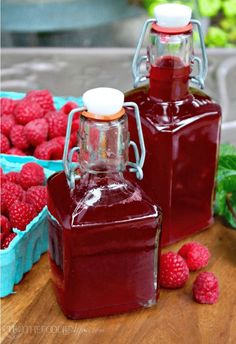 raspberry syrup and fresh raspberries on a table