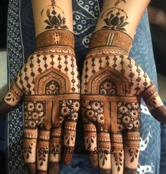 two hands with henna designs on them