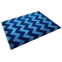 a blue area rug with an abstract design on the top and bottom, in front of a white background