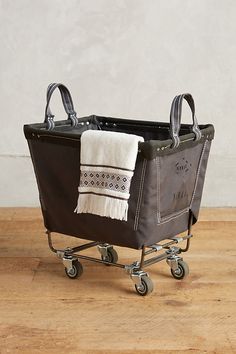 a brown shopping cart with a white towel on it's handle and two handles