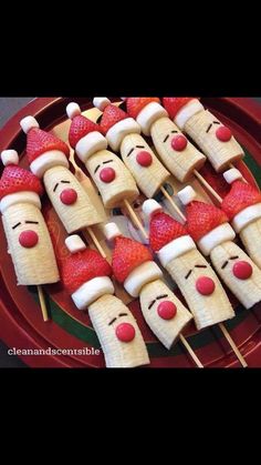 some strawberries are on sticks with faces