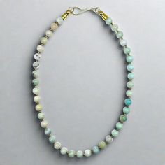 This beaded necklace features pale blue colors of amazonite round beads alternating with 2mm gold plated brass spacers. This piece is finished with a gold plated brass hook. This is a perfect piece for a #neckmess. Length: 18" 8mm Amazonite round beads 2mm Gold plated brass spacer beads Handmade in Lincoln, Nebraska Handmade Amazonite Round Beads Necklaces, Single Strand Amazonite Spiritual Beaded Necklace, Handmade Gold Amazonite Necklaces, Light Blue Single Strand Necklace With Round Beads, Handmade Gold Amazonite Necklace, Gold Single Strand Amazonite Beaded Necklace, Gold Single Strand Beaded Necklace With Amazonite, Adjustable Single Strand Amazonite Beaded Necklace, Beaded Collar Necklace