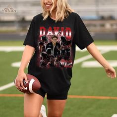 Cheer on your favorite team in style with our Personalized Photo Bootleg Football Girlfriend Shirt! Perfect for football-loving girlfriends or boyfriends, this custom shirt features your partner's photo, along with their favorite football team name and number. Whether you're gearing up for game day or looking for a thoughtful gift, this unique shirt is sure to score major points. It's the perfect way to show your team spirit and celebrate football game day in a fun, personalized way! 👌Super Sof Football Girlfriend Shirts, Game Day Gift, Football Team Names, Football Girlfriend, Girlfriend Shirt, Girlfriend Shirts, Custom Football, Team Name, Unique Shirt