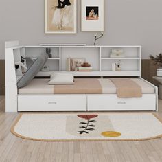 a white bed sitting on top of a wooden floor