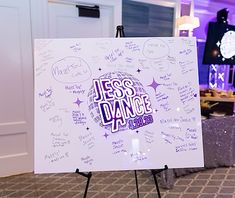 a white board with writing on it in front of a purple light and some lights