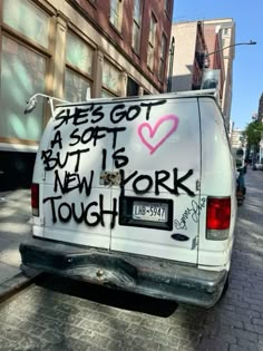 a van with graffiti on it parked in the street