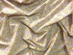 an up close shot of a yellow and white fabric