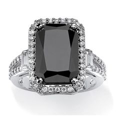 a black and white ring with diamonds on the sides, set in 18k white gold