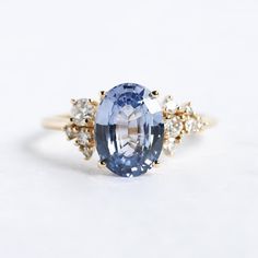 an oval blue and white sapphire ring with diamond accents