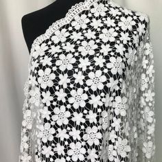 a black and white crochet shawl on a mannequin