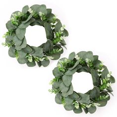 two wreaths with green leaves and white flowers