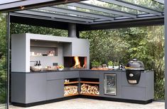 an outdoor kitchen with wood burning in the oven