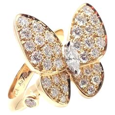 18k Yellow Gold Diamond Two Butterfly Ring by Van Cleef & Arpels. The Authentic Van Cleef & Arpels 18k Yellow Gold Diamond Two Butterfly Ring is a luxurious piece, showcasing two delicate butterflies crafted from 18k yellow gold. The butterflies are adorned with sparkling diamonds, symbolizing transformation and elegance. This exquisite ring is a testament to the brand's craftsmanship and timeless design. This ring comes with a VCA certificate of authenticity and the VCA box. With Round brilliant cut diamond VVS1 clarity, E color 1 Marque shape diamond VVS1 clarity, E color Details: Size: European 48, US 4.5 Weight: 5.8 grams Width: 18mm Stamped Hallmarks: Cartier 750 48 JA558XXX (Serial Omitted) ***Free Shipping Within United States*** Follow us on our 1stDibs storefront to view our weekl Van Cleef Arpels Diamond, Gold Butterfly Ring, Chanel Ring, Gold Vans, Van Cleef & Arpels, Authentic Vans, Gold Cocktail Ring, Butterfly Ring, Van Cleef Arpels