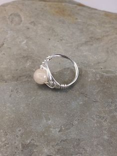 The tranquil beauty of this genuine rainbow moonstone ring is stunning. Moonstone has a soothing nurturing energy. It is the stone of the mother moon. The faceted cut of this gemstone is beautiful in its simplicity. I chose to enhance it with a Celtic inspired silver wire design to let the natural beauty of the moonstone shine. Pair this flattering ring with your favorite outfit, dressed up or down, the possibilities are endless! This ring is handmade by me with a genuine rainbow moonstone. The Adjustable Moonstone Rings With Natural Stones, Minimalist Adjustable Moonstone Ring With Natural Stones, Adjustable Moonstone Promise Ring With Natural Stones, Adjustable Moonstone Crystal Ring With Birthstone, Adjustable Moonstone Ring For Healing, Adjustable Moonstone Healing Ring, Adjustable Hand Wrapped Moonstone Ring, Minimalist Moonstone Ring For Healing, Spiritual Open Moonstone Ring For Healing