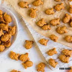 some food that is on a table next to a bowl and paper towel with something in it