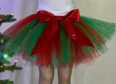 a woman wearing a green and red tutu skirt