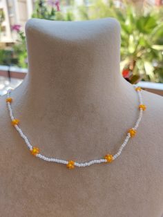 A pretty necklace perfect for everyday wear. So cute and dainty this layering necklace looks lovely on it's own on layered with other necklace. Daisy beaded necklace is an excellent and elegant gift for your lovelies. Choker necklace is made of white and orange bead. You can wear the seed bead necklace to a wedding party and look very special. This tiny choker is made of glass beads. Please select necklace length from the drop-down menu or request an arbitrary length. If you would like a bigger/smaller size please contact me. You can press the contact button. Summer Flower Charm Necklace As A Gift, White Flower Necklace With Colorful Beads For Summer, Summer Flower Charm Necklace As Gift, Cute Flower Necklaces For Summer, Summer Flower Charm Necklace For Gift, Cute Flower Necklace For Summer, White Summer Flower Necklace With Colorful Beads, Summer White Flower Necklace With Colorful Beads, Summer Gift Necklace With Flower Charm