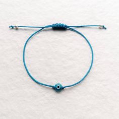 Evil eye bracelet with blue string, tiny silver beads and macrame sliding knot for adjustable size ★ Details *Tiny aqua blue evil eye glass bead 6mm *Tiny silver beads 3mm *Blue nylon string 1mm *Adjustable size with macrame sliding knot ★ Gift wrapping and packaging All items are shipped in a beautiful gift pack with the card of the photo or in an organza pouch (depending on items), securely packed in a bubble wrap envelope. Please contact me if you want a personalized card. ★ Shipping This ite Adjustable Evil Eye Friendship Bracelets, Adjustable Evil Eye Bracelet With Sliding Knot, Blue Adjustable Evil Eye Bracelet, Adjustable Blue Evil Eye Bracelet, Adjustable Blue Evil Eye Bracelet For Spiritual Purposes, Adjustable Spiritual Evil Eye Bracelet With Sliding Knot, Adjustable Blue Macrame Jewelry, Blue Spiritual Bracelet With Adjustable Cord, Spiritual Blue Bracelets With Adjustable Cord