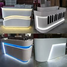 four different types of reception desks with lights