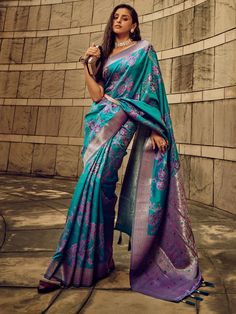 Made from high-quality silk material, this saree features intricate threadwork and zari weaving that adds a touch of elegance to the overall look. The vibrant turquoise color of the saree is sure to make you stand out at any wedding or festival event.
This saree includes a 5.50-meter length, making it perfect for draping in various traditional styles. The unstitched blouse material in a beautiful purple color with zari weaving complements the saree perfectly, giving you a complete and coordinate Buy Salwar Kameez Online, Silk Banarasi Saree, Cyan Colour, Lehenga Choli Wedding, Bollywood Lehenga, Satin Saree, Bridal Lehenga Choli, Designer Lehenga Choli, Banarasi Saree