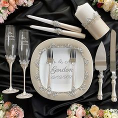 the table is set with silverware, flowers and napkins for an elegant wedding