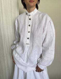 "Vintage White Linen Blouse Size S - L | Long Sleeve White Linen Top with small pleats and metallic buttons. Very nice collar detail. Composition: 100% linen.  Measurements of the vintage white linen blouse lying flat: chest: 55 cm | 21.7\" length: 76 cm | 29.9\" sleeves: 62 cm | 24.4 shoulder to shoulder: 50 cm | 19.7\" In perfect condition. The model wearing this white summer blouse is 1,68 m | 5.5 foot tall; Chest: 88 cm | 35\", waist: 68 cm | 26\", hips: 88 cm | 35\". The white full skirt wi Vintage Linen Tops With Relaxed Fit, Vintage Linen Top With Relaxed Fit, White Linen Tops With Buttons, White Linen Top With Buttons, Classic Linen Blouse With Buttons, Vintage Linen Button-up Tops, Vintage Linen Blouse With Buttons, White Linen Blouse With Button Cuffs, Linen Button Tops For Daywear